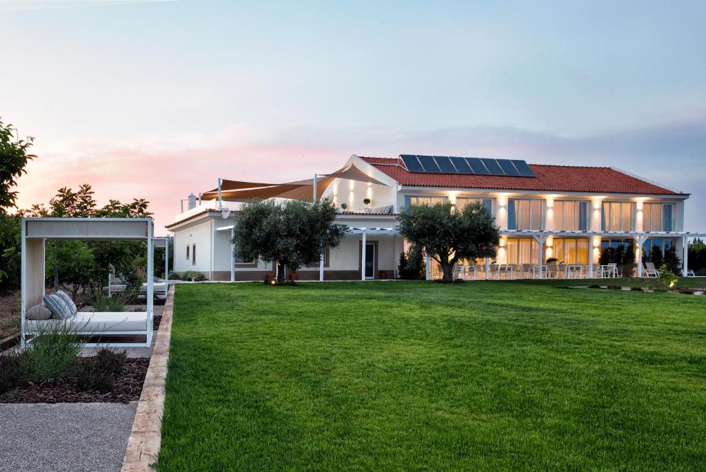 a house with solar panels on the roof at Quinta Dos Perfumes in Tavira