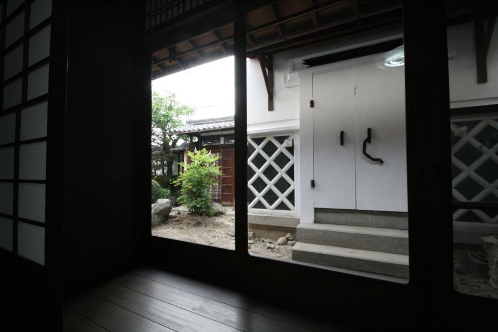a view from the inside of a house with a window at HARUYA Naramachi in Nara