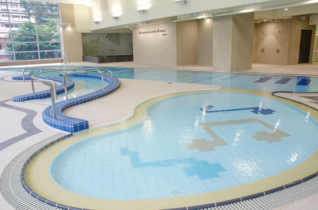 a large swimming pool in a building at The Salisbury - YMCA of Hong Kong in Hong Kong
