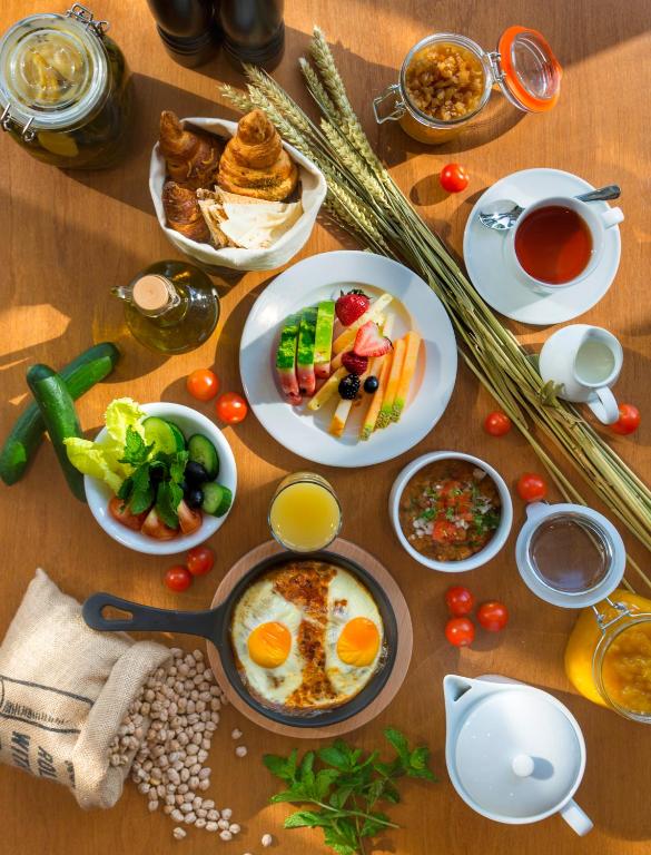 a table topped with plates of breakfast foods and drinks at Canal Central Hotel Business Bay in Dubai