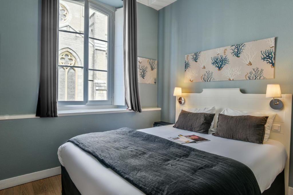 Voodi või voodid majutusasutuse Hotel De L'Océan toas