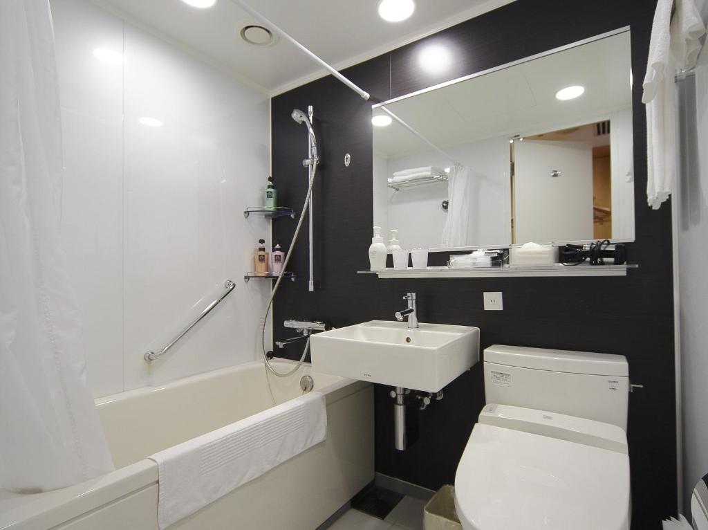a bathroom with a white toilet and a sink at Hotel Granvia Wakayama in Wakayama