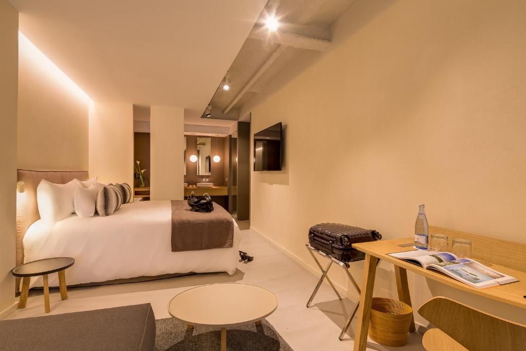 a hotel room with a bed and a desk at Ohla Eixample in Barcelona