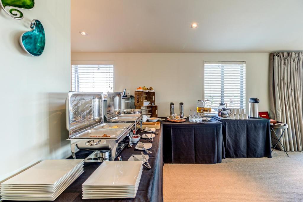 a kitchen with a table with food on it at Parkview On Hagley in Christchurch
