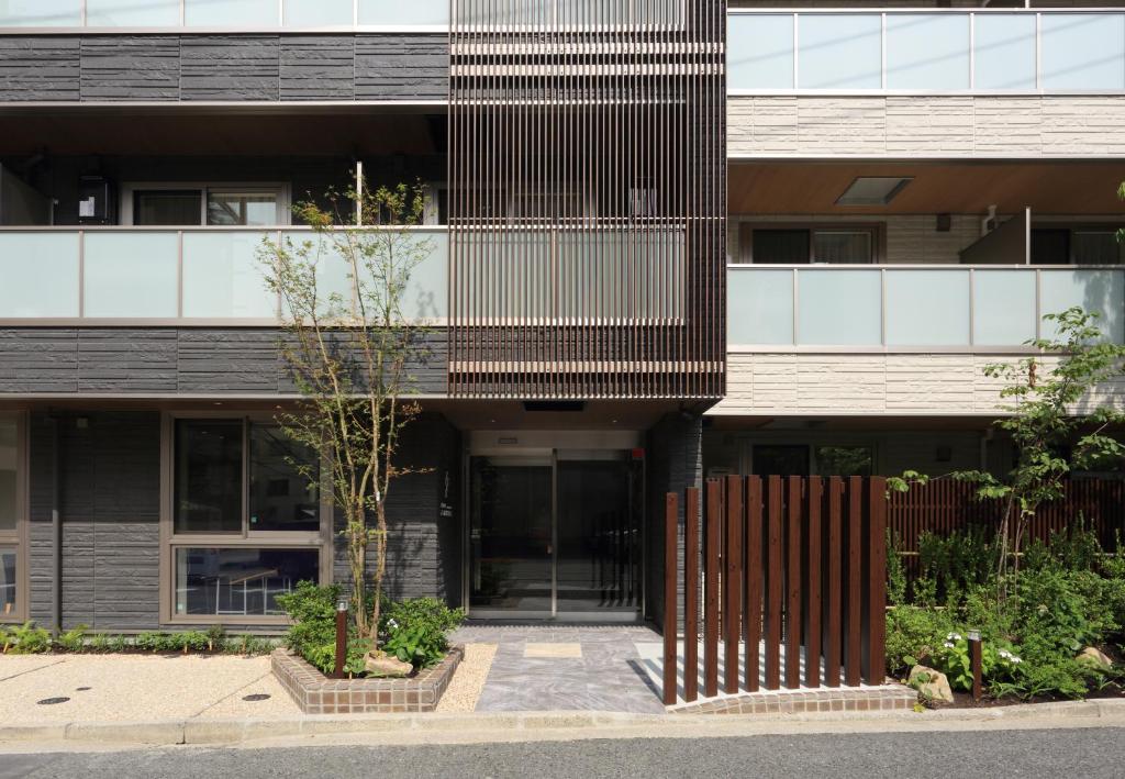 an external view of a building with a fence at HOTEL PROMOTE HIROSHIMA in Hiroshima