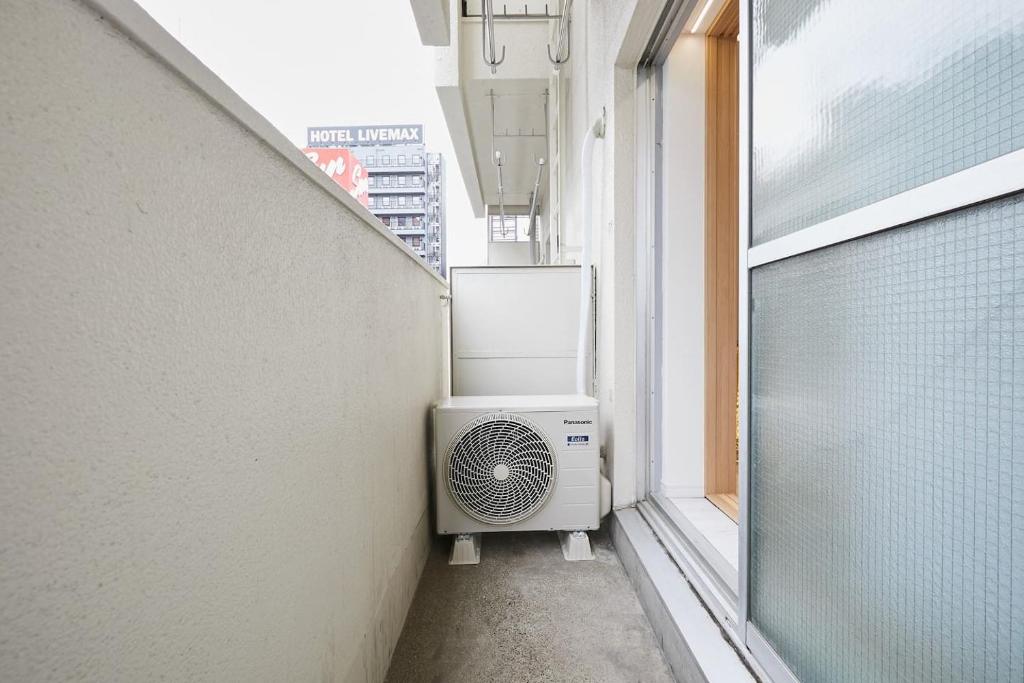 a room with a air conditioner sitting in a window at STAY ARI Kabukicho in Tokyo