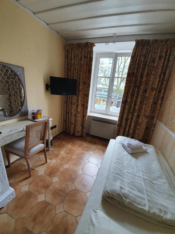 Un pat sau paturi într-o cameră la Pension Seibel