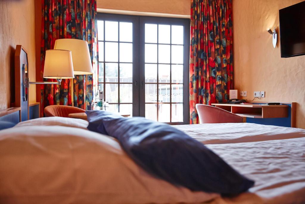 Giường trong phòng chung tại Hotel und Restaurant Bommersheim
