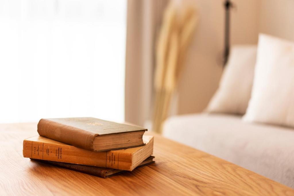 two books sitting on a table next to a bed at GIVE Higashi Nakano in Tokyo