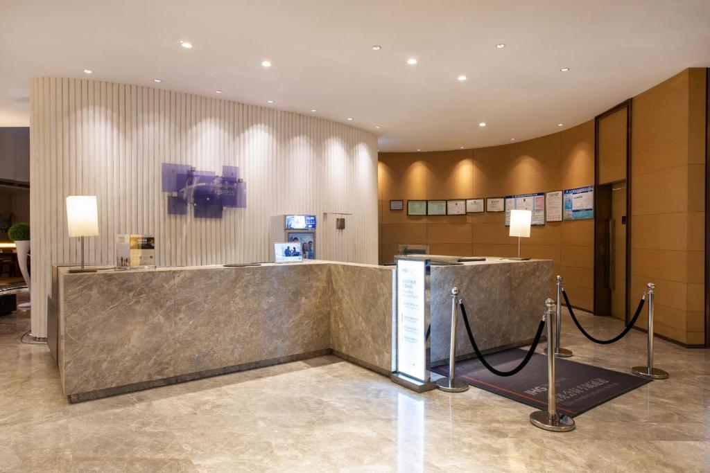 a lobby with a large marble counter in a building at Holiday Inn Express Shenyang Golden Corridor by IHG in Shenyang