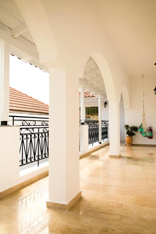 a large room with white walls and a wooden floor at Hotel Port 7- Boutique Collection in Agios Nikolaos