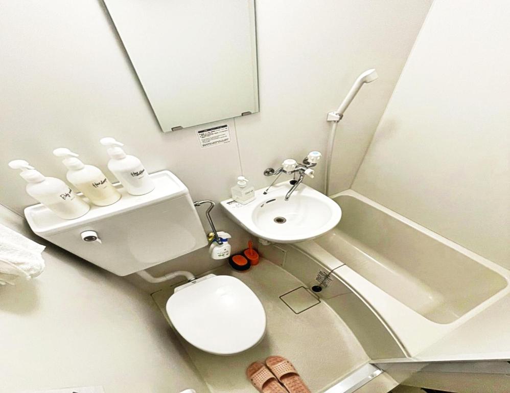 a small bathroom with a toilet and a sink at ☆Cozy Japanese style room☆ in Tokyo