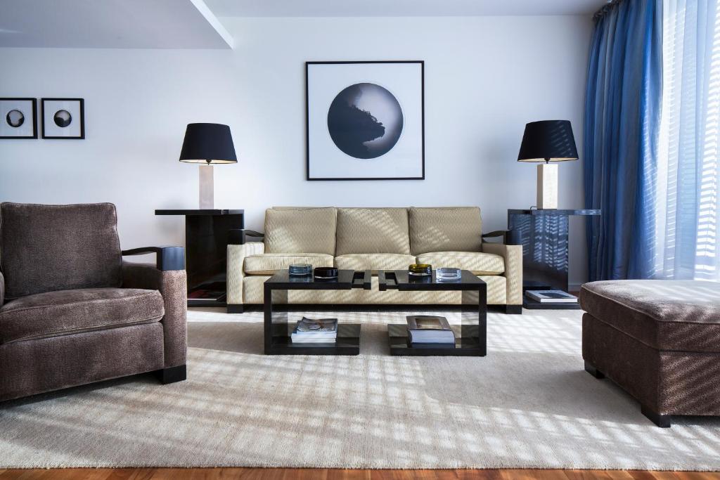 a living room with a couch and a coffee table at The Mandala Berlin, a Member of Design Hotels in Berlin