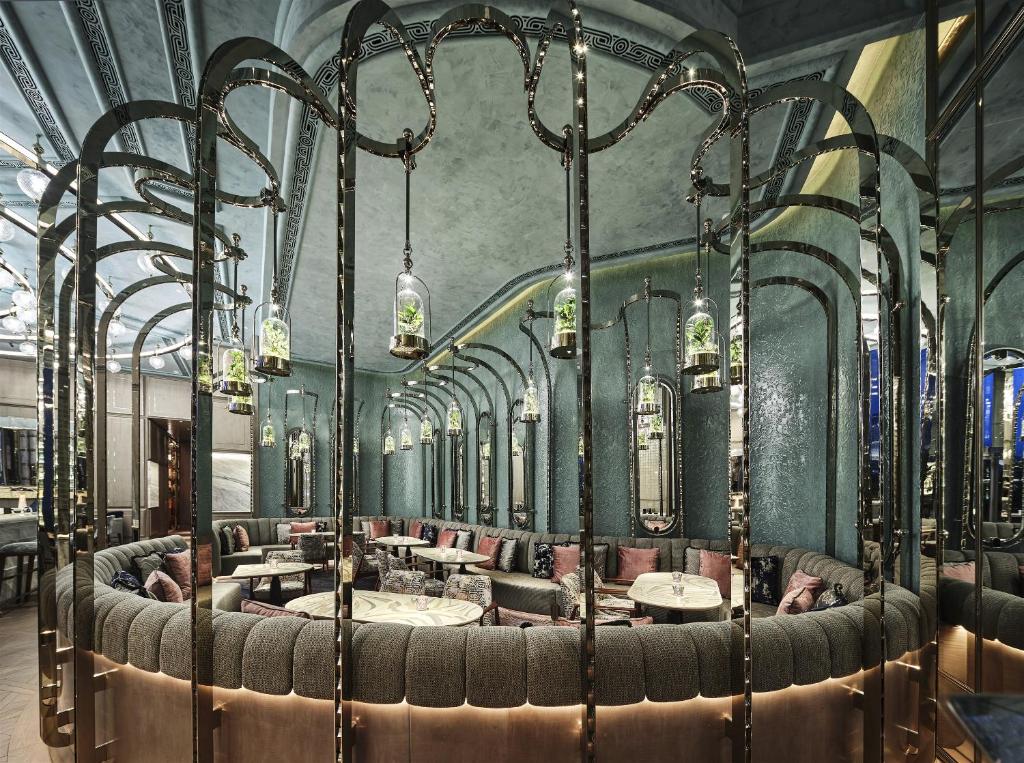 a restaurant with tables and chairs in a room at Four Seasons Hotel Hong Kong in Hong Kong