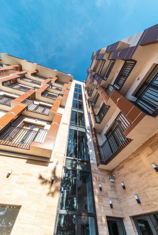 a tall building with windows on the side of it at Hotel Residence Plaza in Tbilisi City