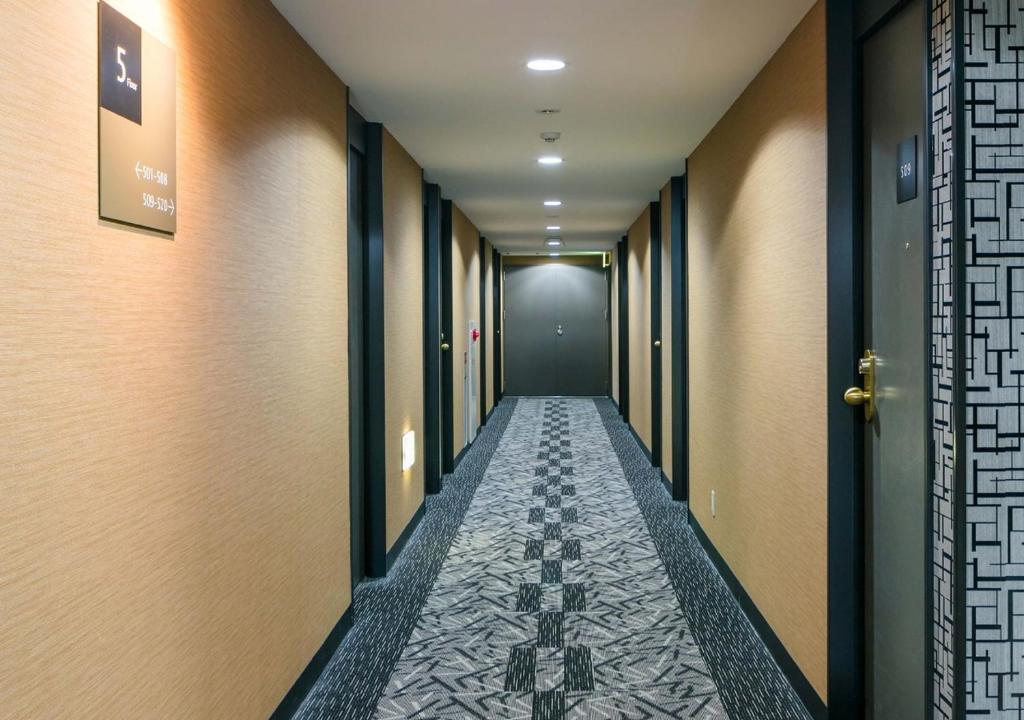 a corridor of a corridor with a long hallway at APA Hotel Nagasaki Ekiminami in Nagasaki