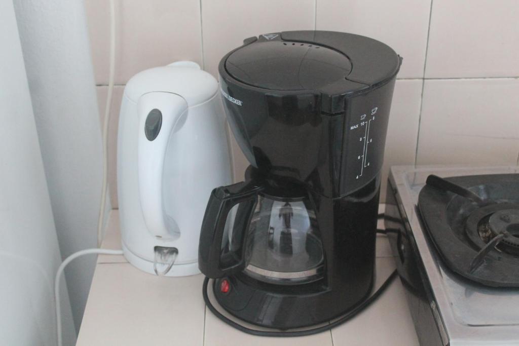 a black and white coffee maker on a counter at Auberge Miko in Grand Baie
