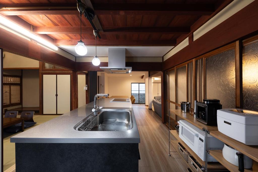 a kitchen with a sink and a counter top at 風早邸海音 kazahayatei mion in Hōjō