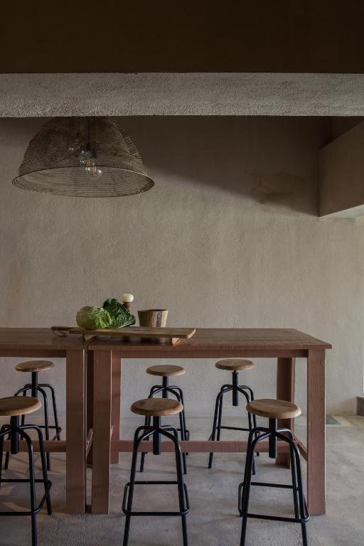 a table with a bowl of vegetables on top of it at Azenhas do Mar Valley House in Sintra