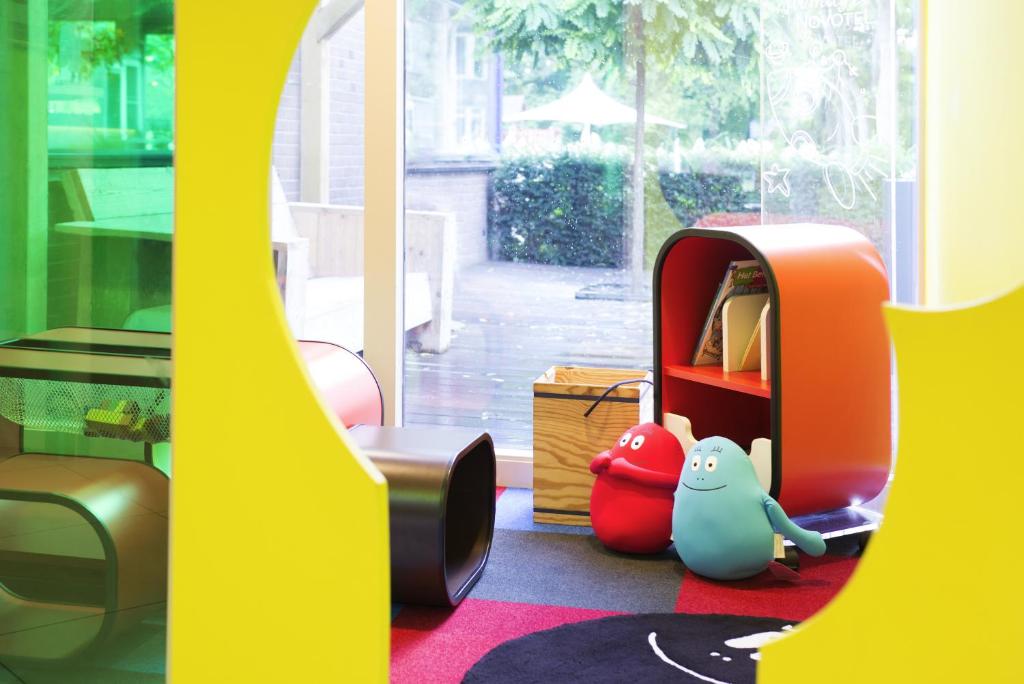 a room with a table and some toys on the floor at Novotel Rotterdam - Schiedam in Schiedam