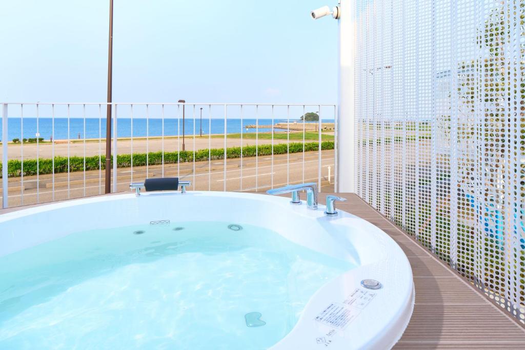 a large bath tub in a room with a large window at WHARFandCO in Himi