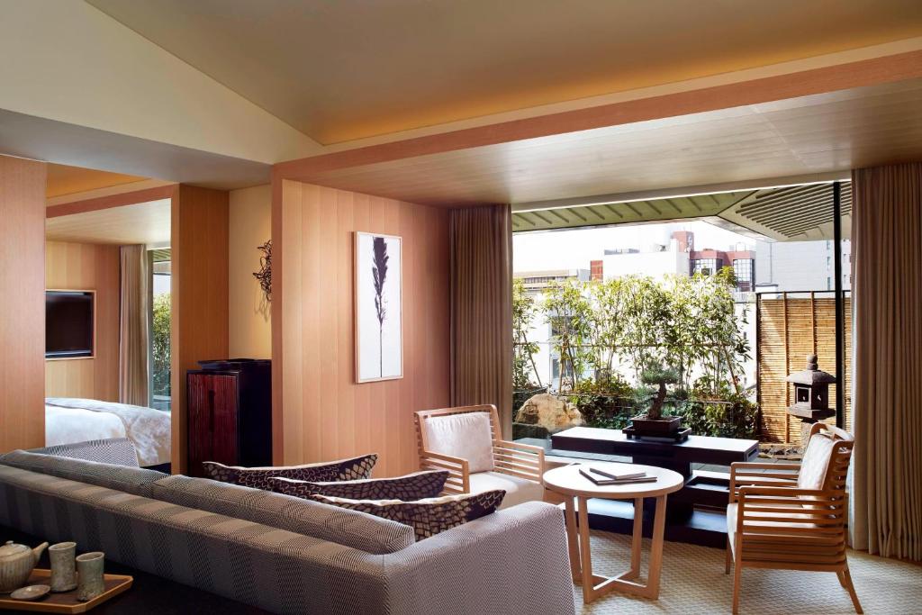 a living room with a couch and a table at The Ritz-Carlton Kyoto in Kyoto