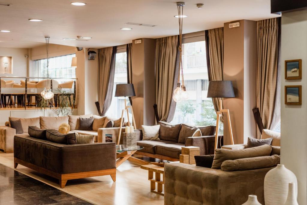 a living room with two couches and a table at Acropolis Select in Athens