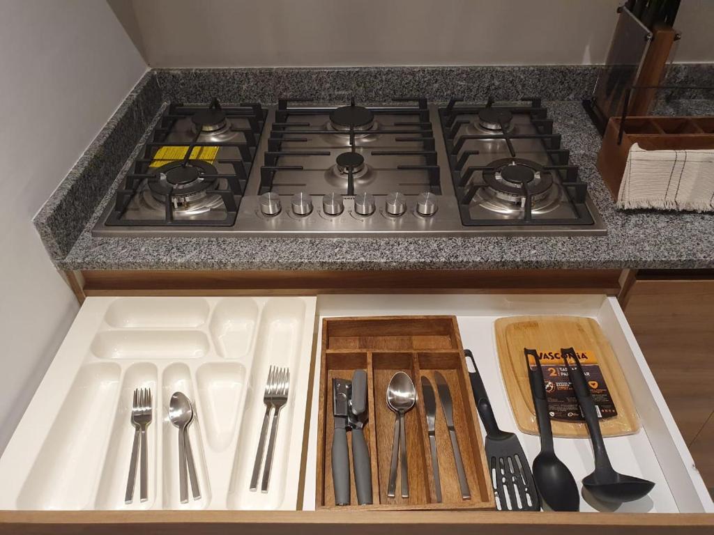 a kitchen counter with a stove with utensils on it at Mako 54 in Puerto Vallarta