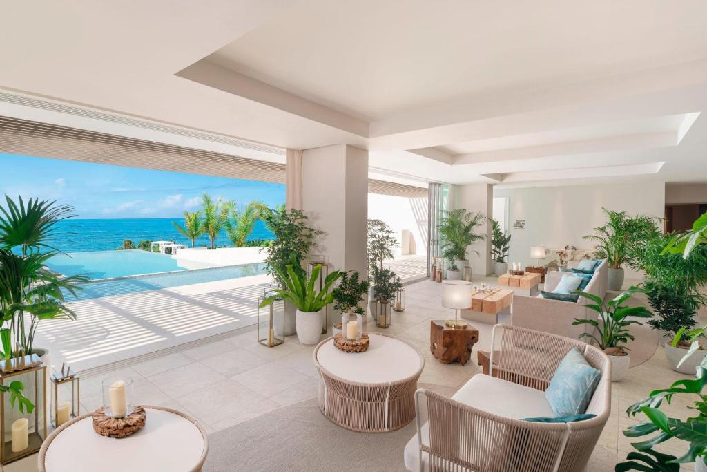 a living room with a view of the ocean at IRAPH SUI, a Luxury Collection Hotel, Miyako Okinawa in Miyako-jima