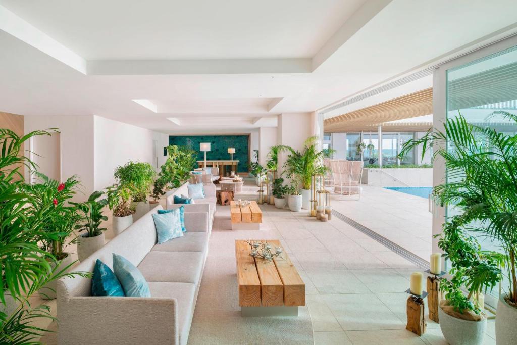 a lobby with potted plants and a table at IRAPH SUI, a Luxury Collection Hotel, Miyako Okinawa in Miyako-jima
