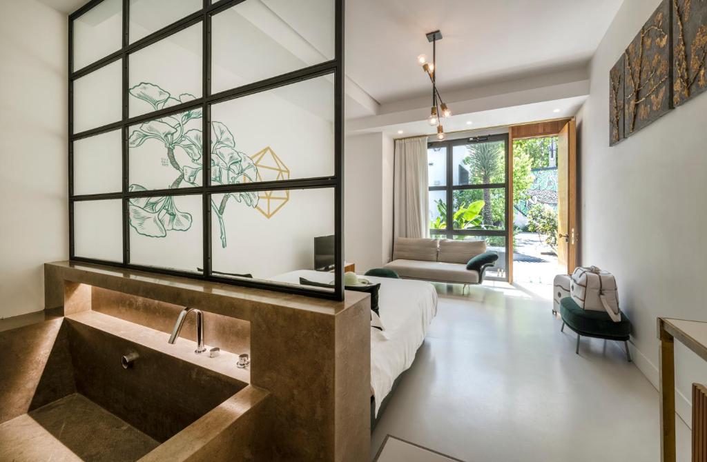 a bathroom with a large tub and a large window at Horti 14 Borgo Trastevere Hotel in Rome