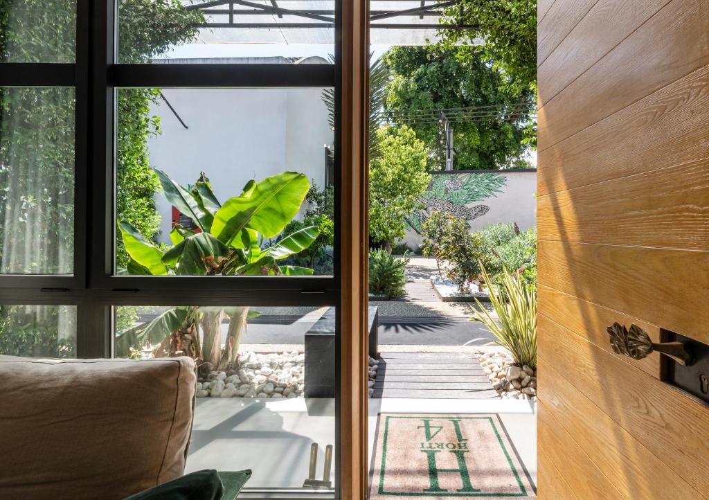 a room with a window looking out at a garden at Horti 14 Borgo Trastevere Hotel in Rome