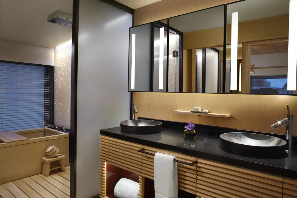 a bathroom with two sinks and a tub at The Ritz-Carlton Kyoto in Kyoto