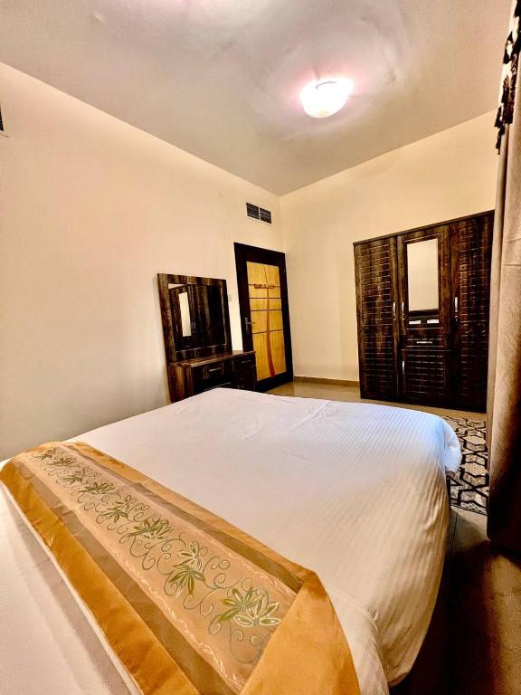 a bedroom with a large white bed in a room at Dream Palace Hotel in Ajman 