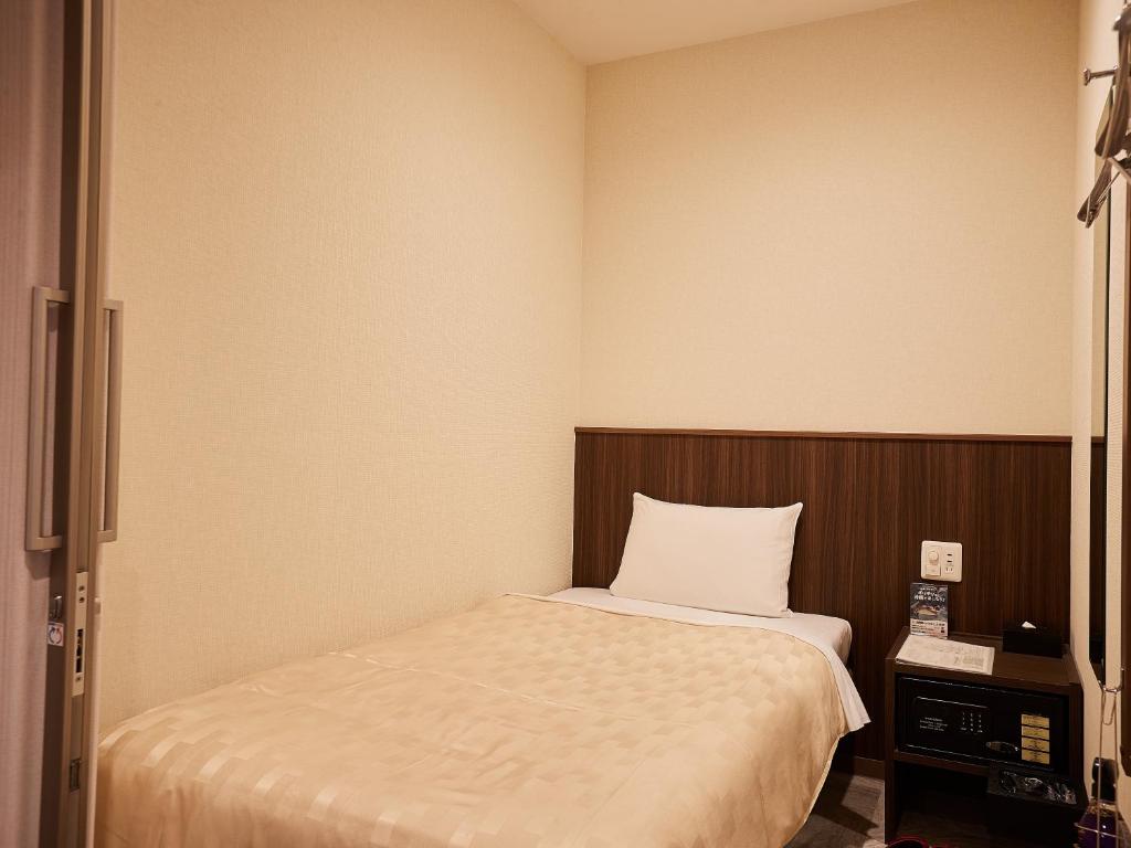 Letto o letti in una camera di Grand Cabin Hotel Naha Oroku