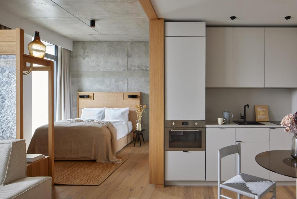 a small bedroom with a bed and a kitchen at Locke at East Side Gallery in Berlin