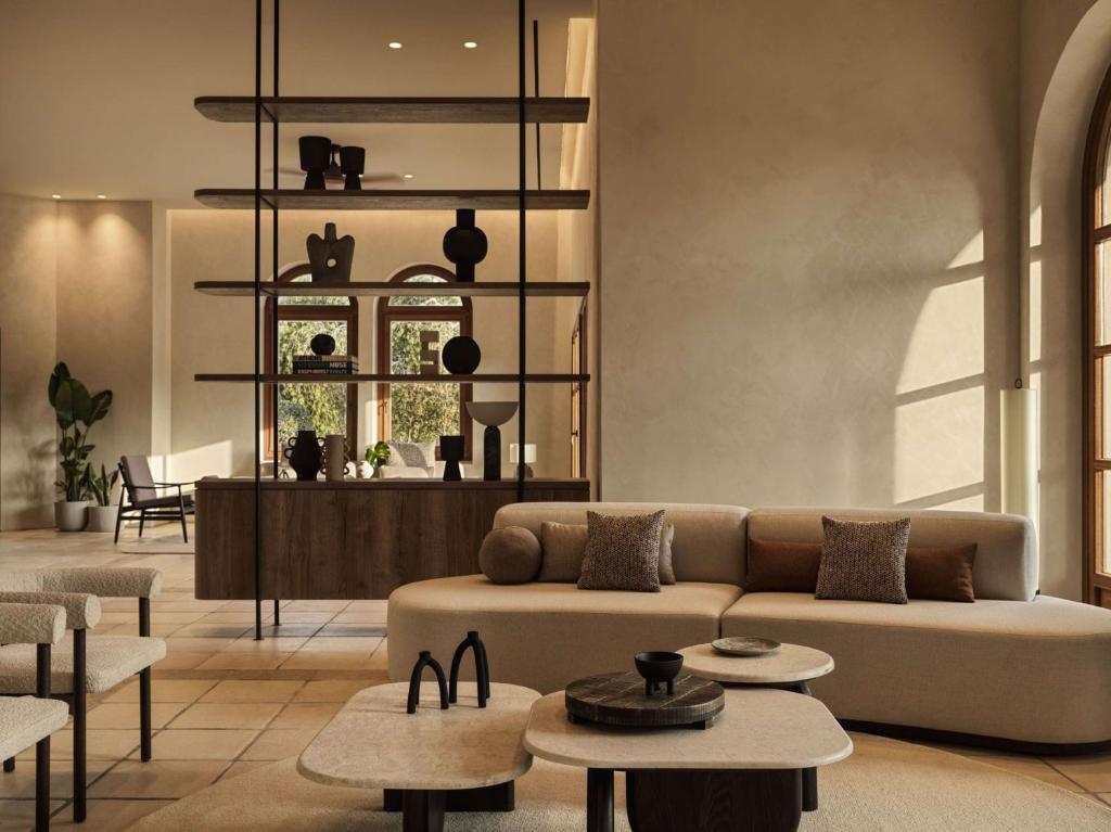 a living room with a couch and tables at Lindian Village All Inclusive Resort Rhodes,Curio Collection in Kiotari