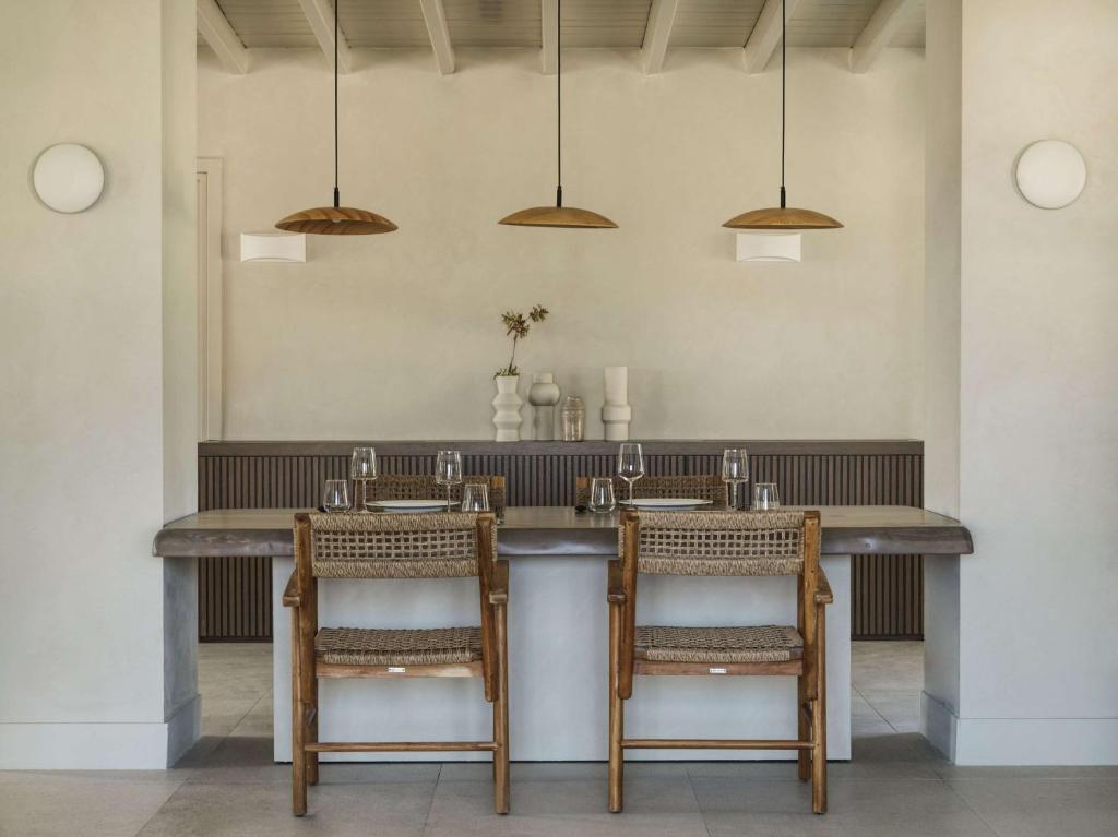 a kitchen with a large table with two chairs at Lindian Village All Inclusive Resort Rhodes,Curio Collection in Kiotari