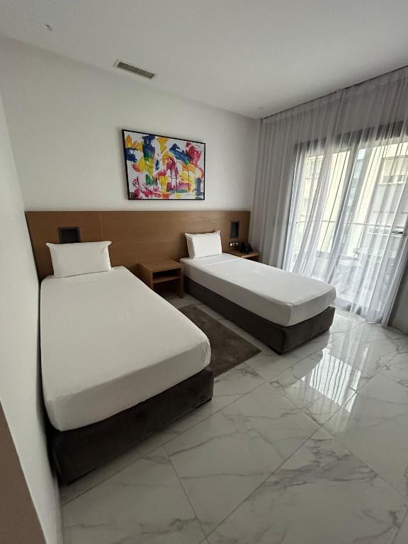 Kama o mga kama sa kuwarto sa Twin Hotel Tanger