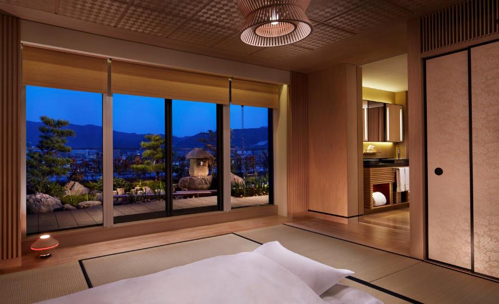 a bedroom with a large window with a view at The Ritz-Carlton Kyoto in Kyoto