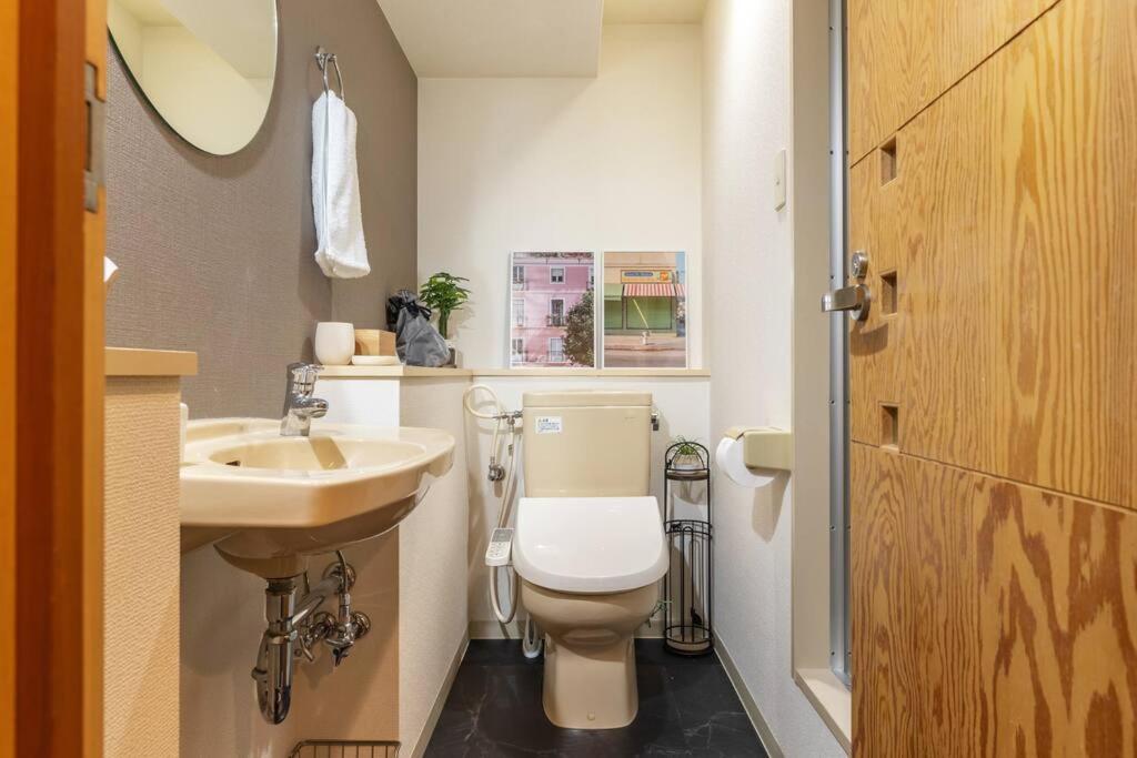 a bathroom with a white toilet and a sink at Cozy Stay Sapporo Central 301 in Toyohira