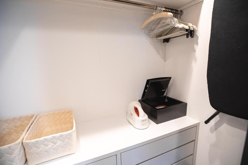 a white counter with a hair dryer and a black box at GOLD STAY Nagoya Osu in Nagoya