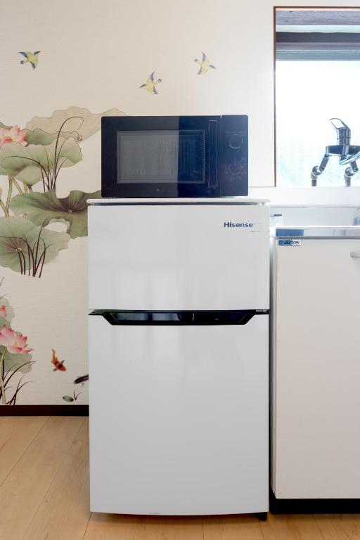 a microwave oven sitting on top of a white refrigerator at Hakone No Yado in Hakone