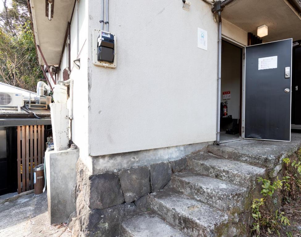 a building with stairs leading to a door at Hakone No Yado in Hakone