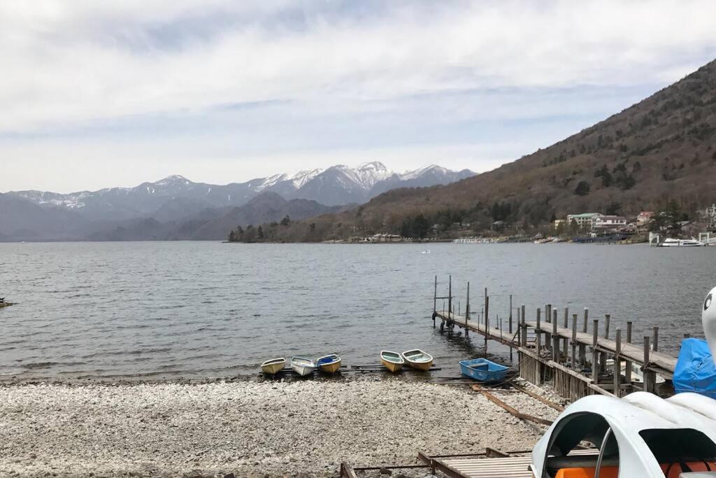 a group of boats sitting on the shore of a lake at 4BR only 1 stop away from Nikko attractions in Nikko