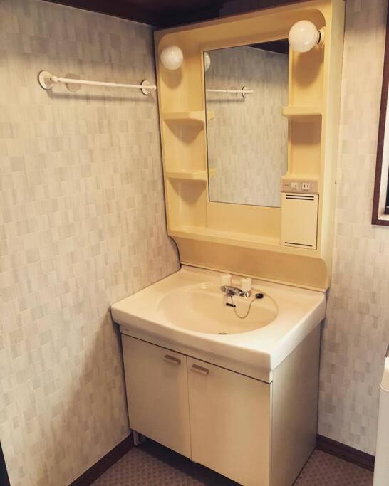 a bathroom with a sink and a mirror at 4BR only 1 stop away from Nikko attractions in Nikko