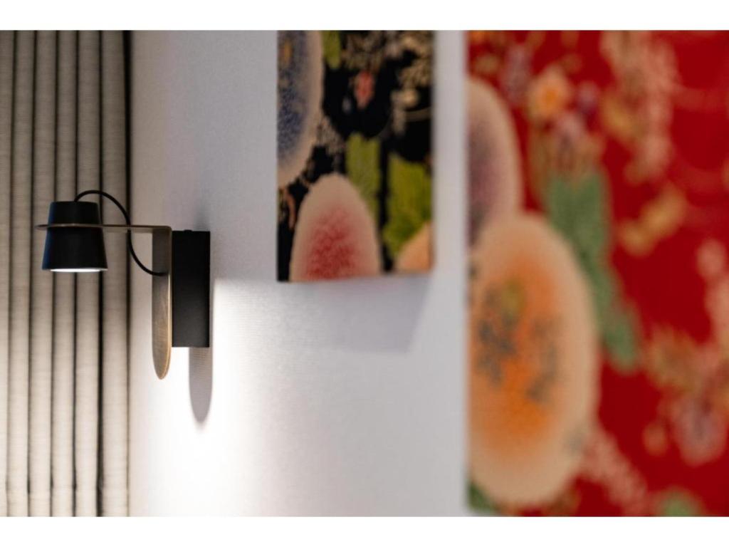 a light hanging on a wall with pictures on it at Hotel Emit Shibuya - Vacation STAY 40890v in Tokyo