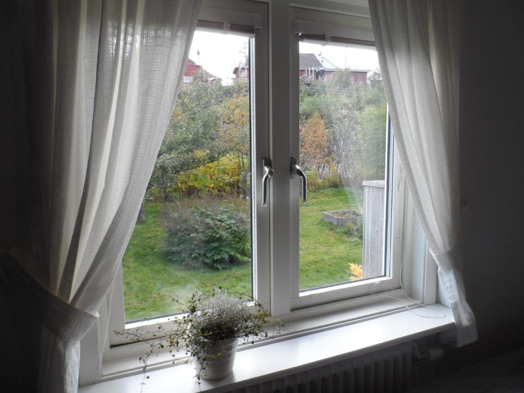 a window with a view of a yard at Landvetter BnB in Härryda