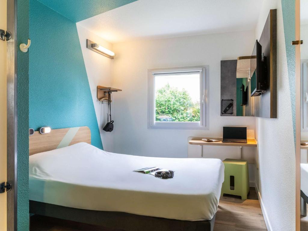 Säng eller sängar i ett rum på ibis budget Orly Rungis