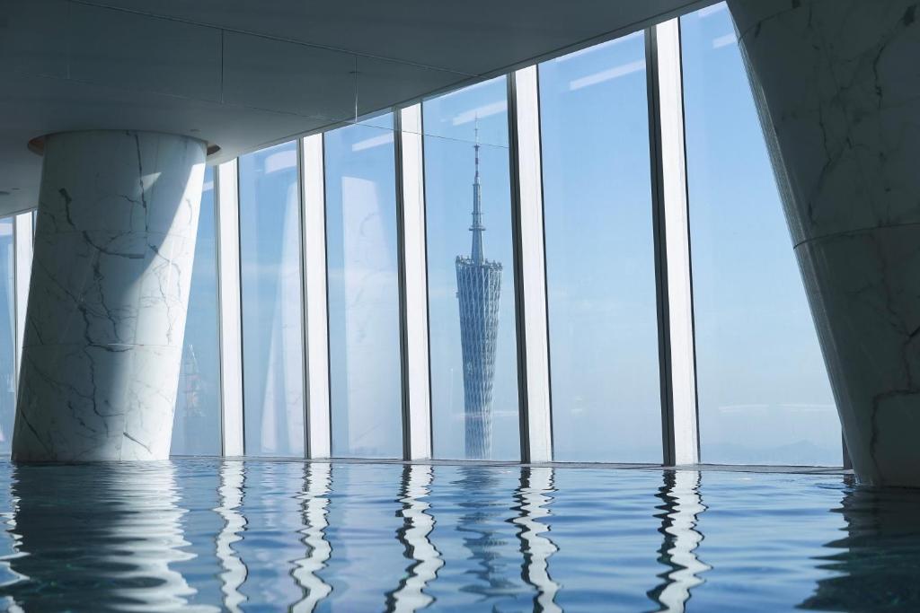 a view of the burj khalifa from a swimming pool in a building at Four Seasons Hotel Guangzhou in Guangzhou